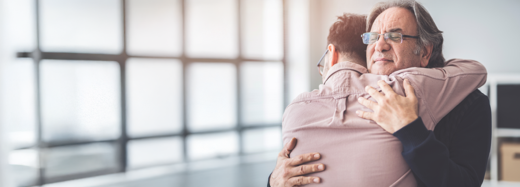 Two people share a heartfelt hug