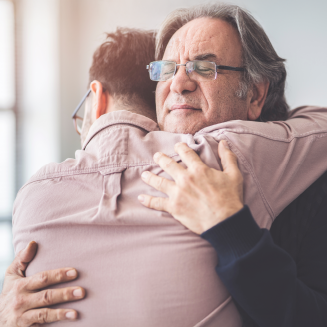 Two people share a heartfelt hug